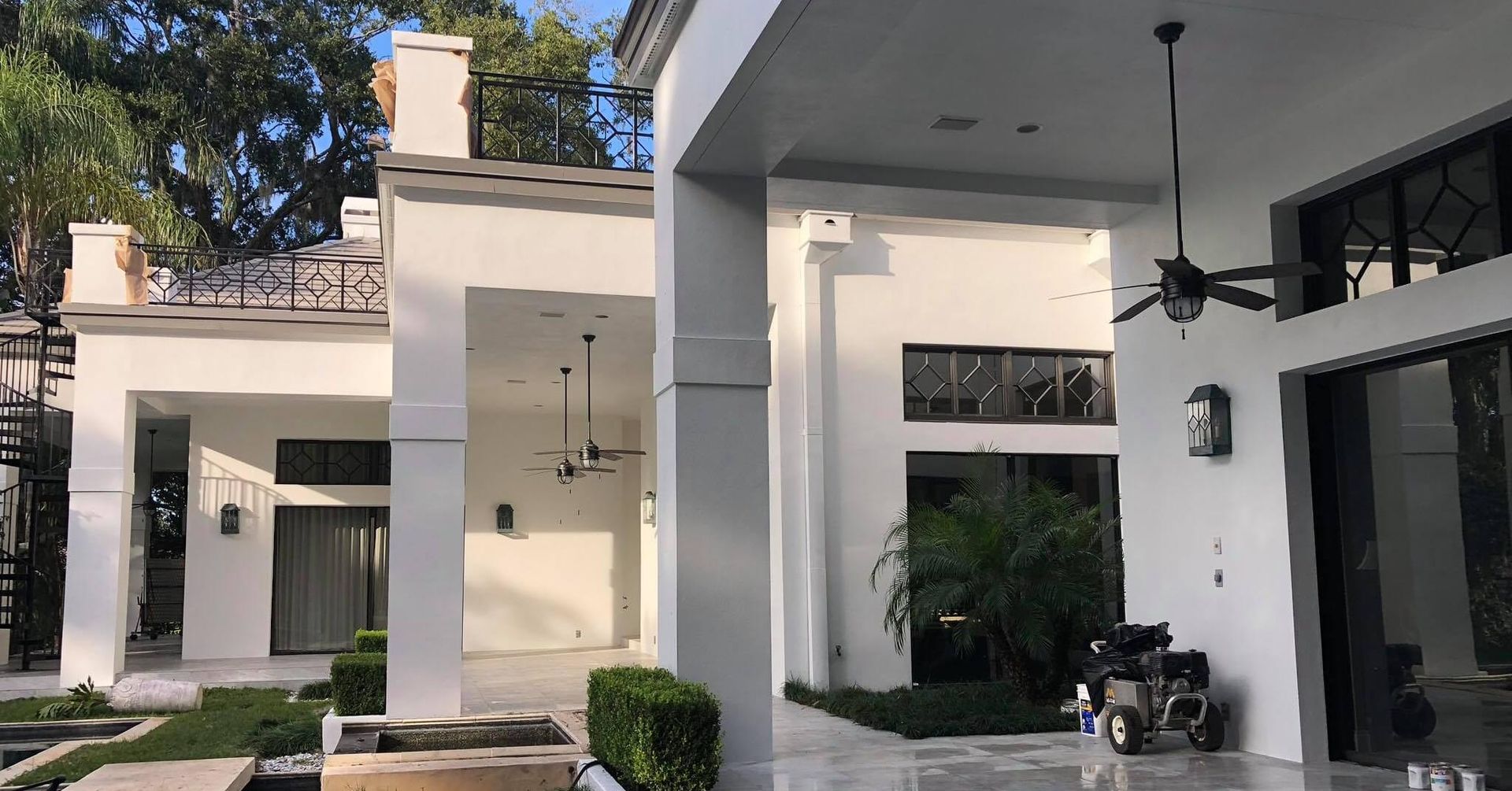 A white house with a motorcycle parked in front of it.