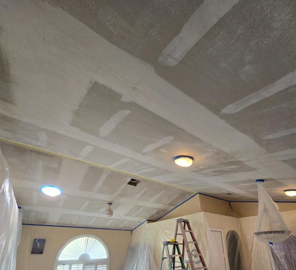 A room that is being remodeled with drywall and a ladder.
