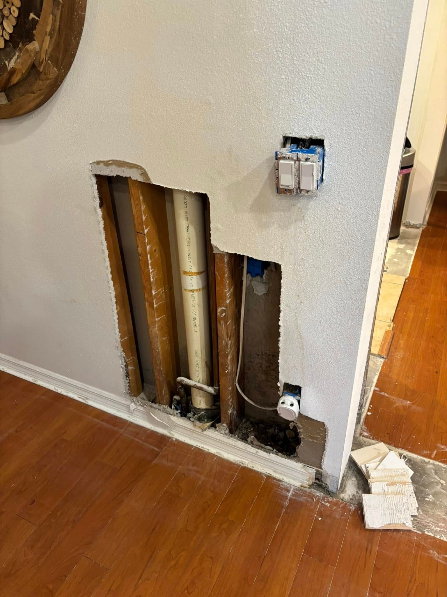 A ceiling with a hole in it and a garage door opener.