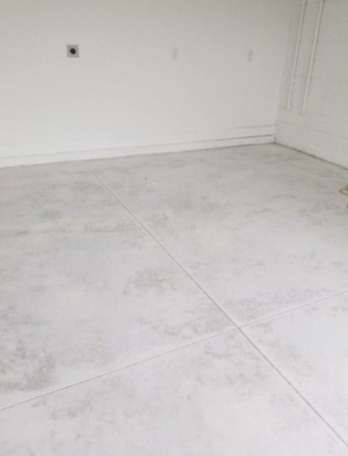 A living room with a couch and a television before being painted.