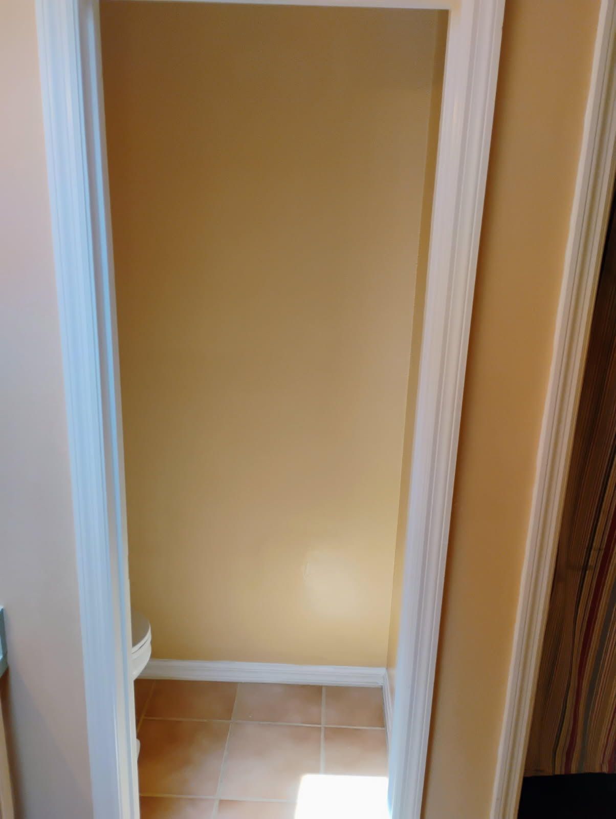 A before picture of a house with a red garage door.