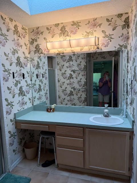 A before picture of a house with a palm tree in front of it.