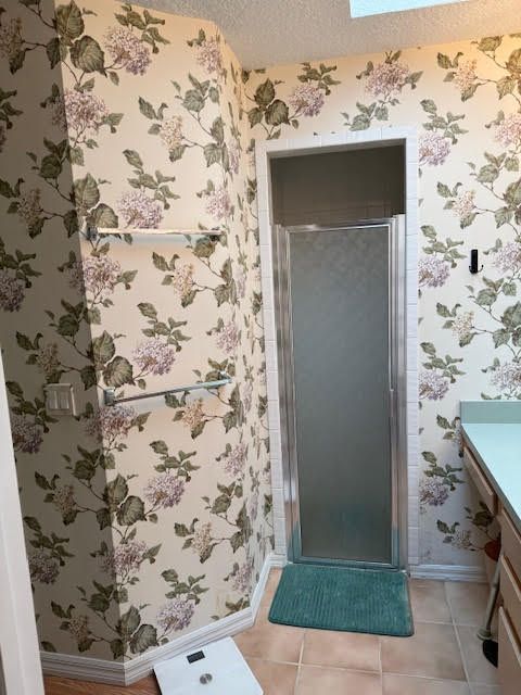 A before picture of a house with a red garage door.