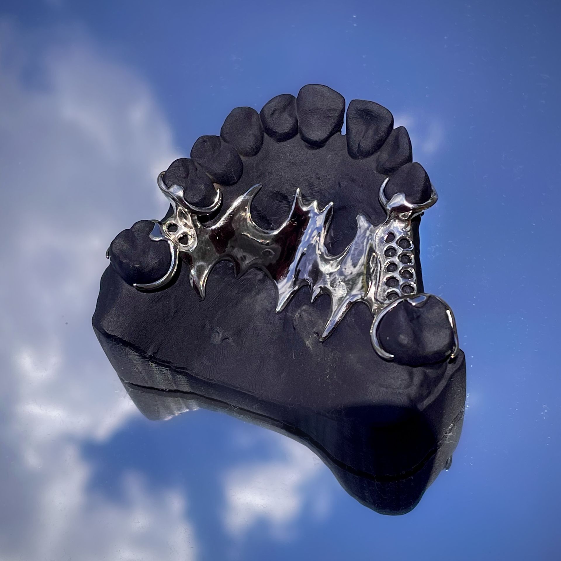 A model of a tooth with a blue sky in the background