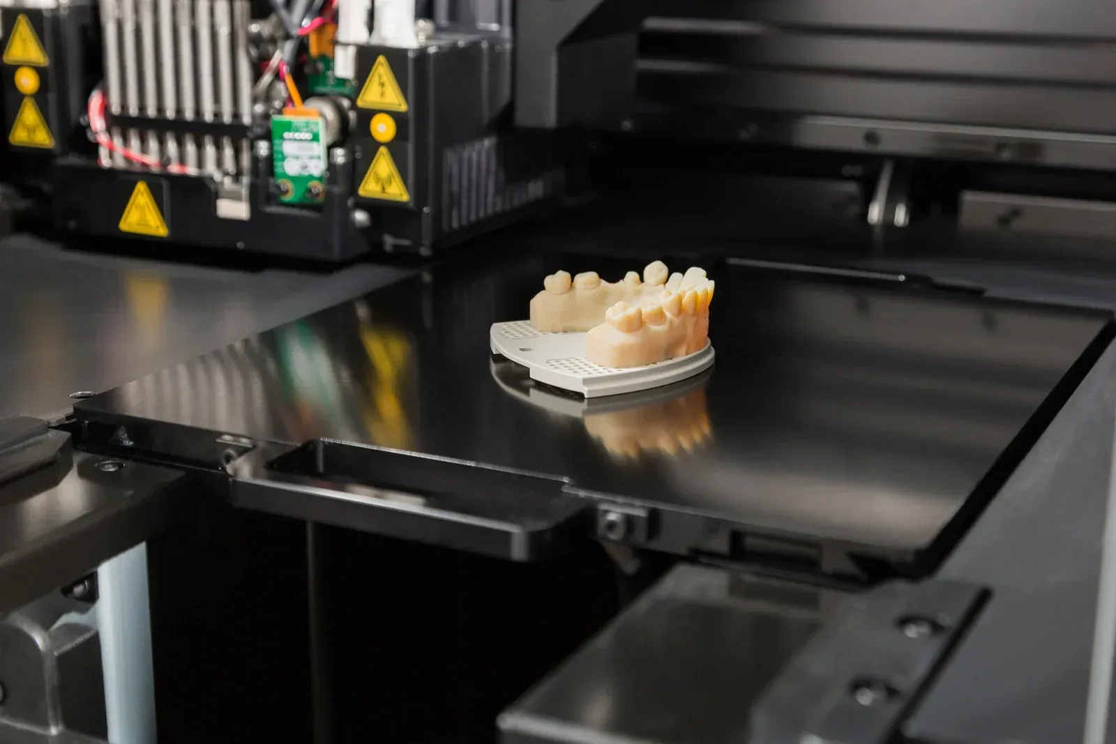 A dental model is being printed on a 3d printer.