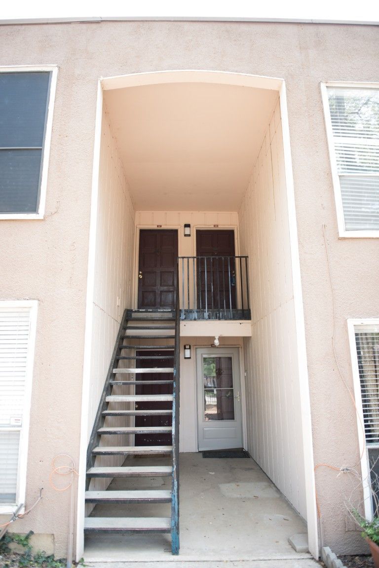 A building with stairs leading up to the second floor