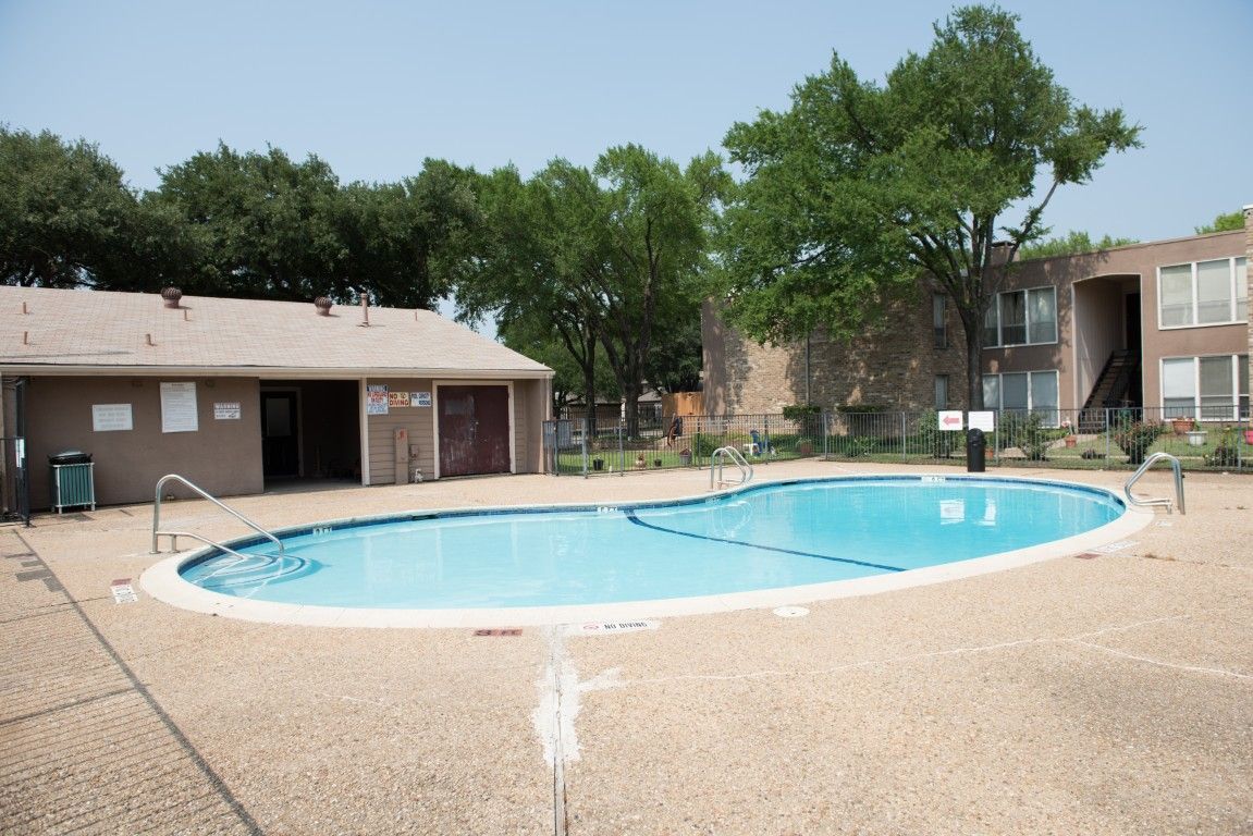 A large swimming pool with a building in the background