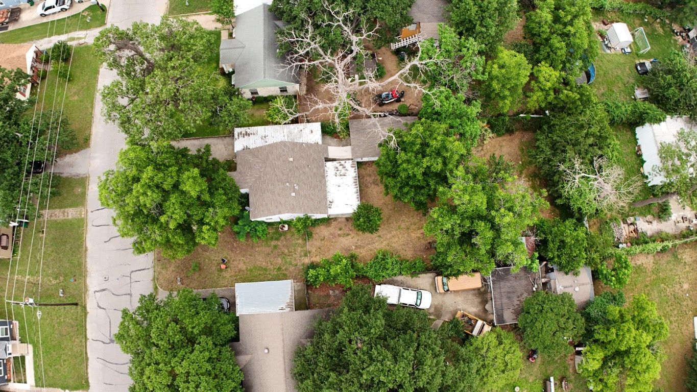 An aerial view of a residential area with lots of trees and houses.