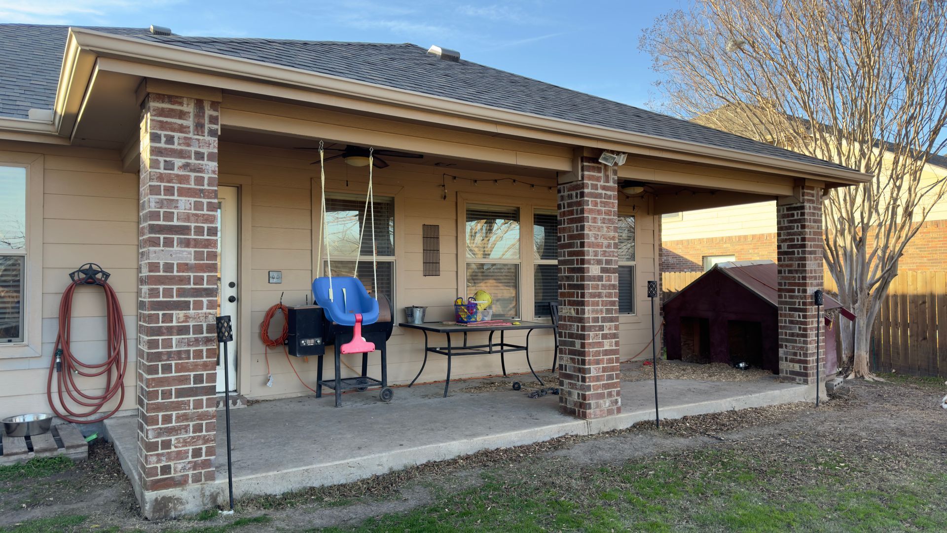 A house with a porch and a table and chairs on it.