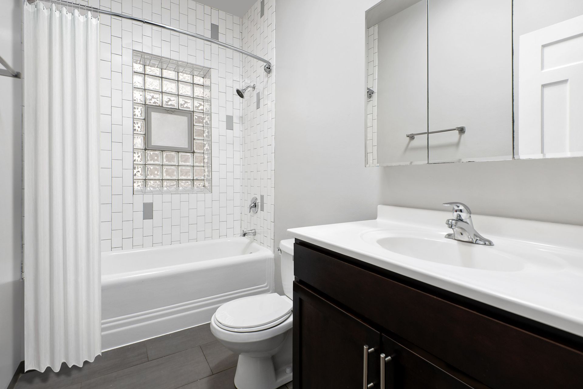 A bathroom with a toilet, sink, and bathtub at 429 W Melrose Street.