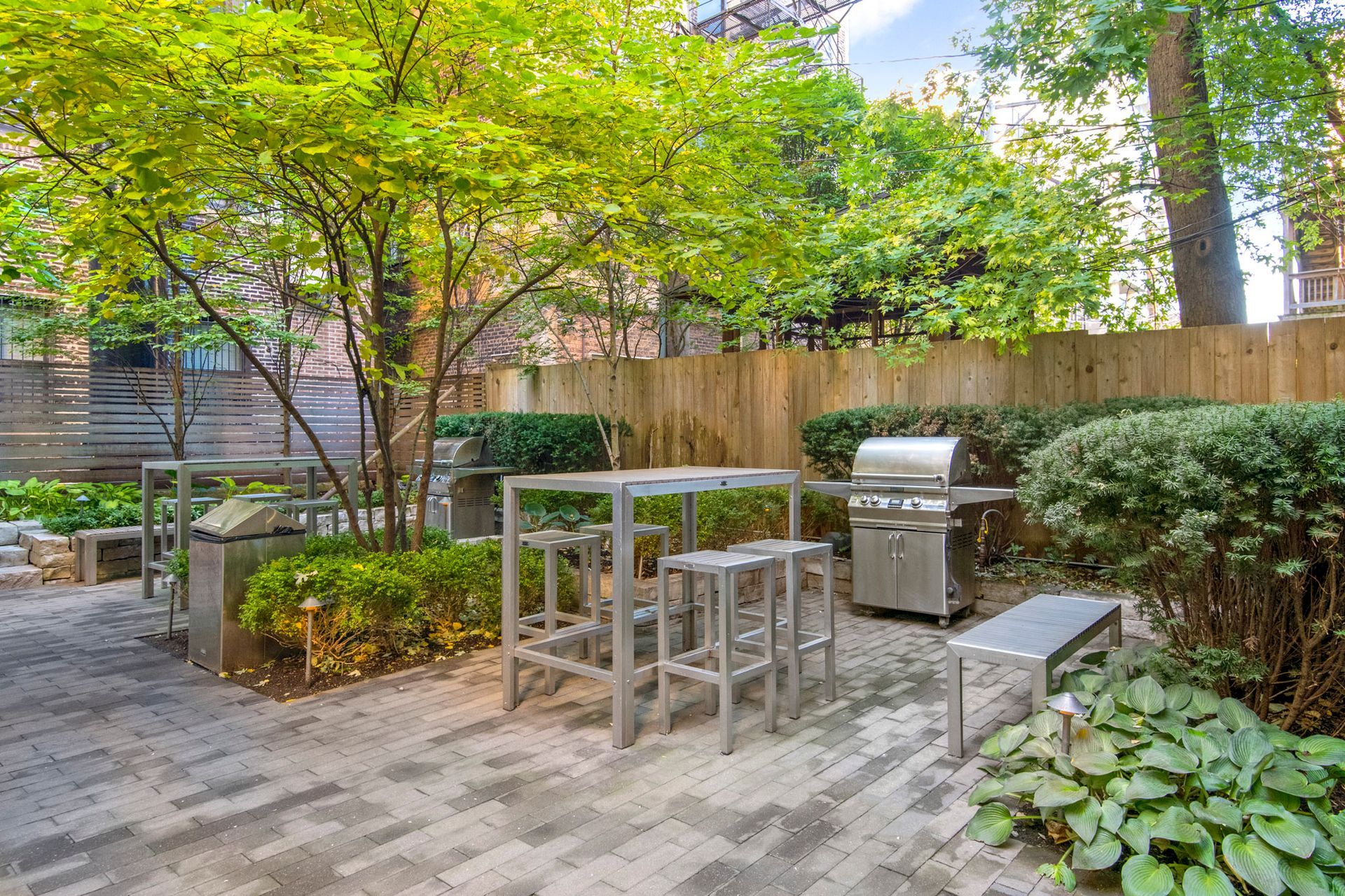 Outdoor area with a grill and tables at 429 W Melrose Street.
