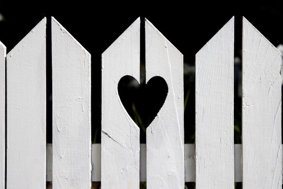 White picket fence with a heart cutout.