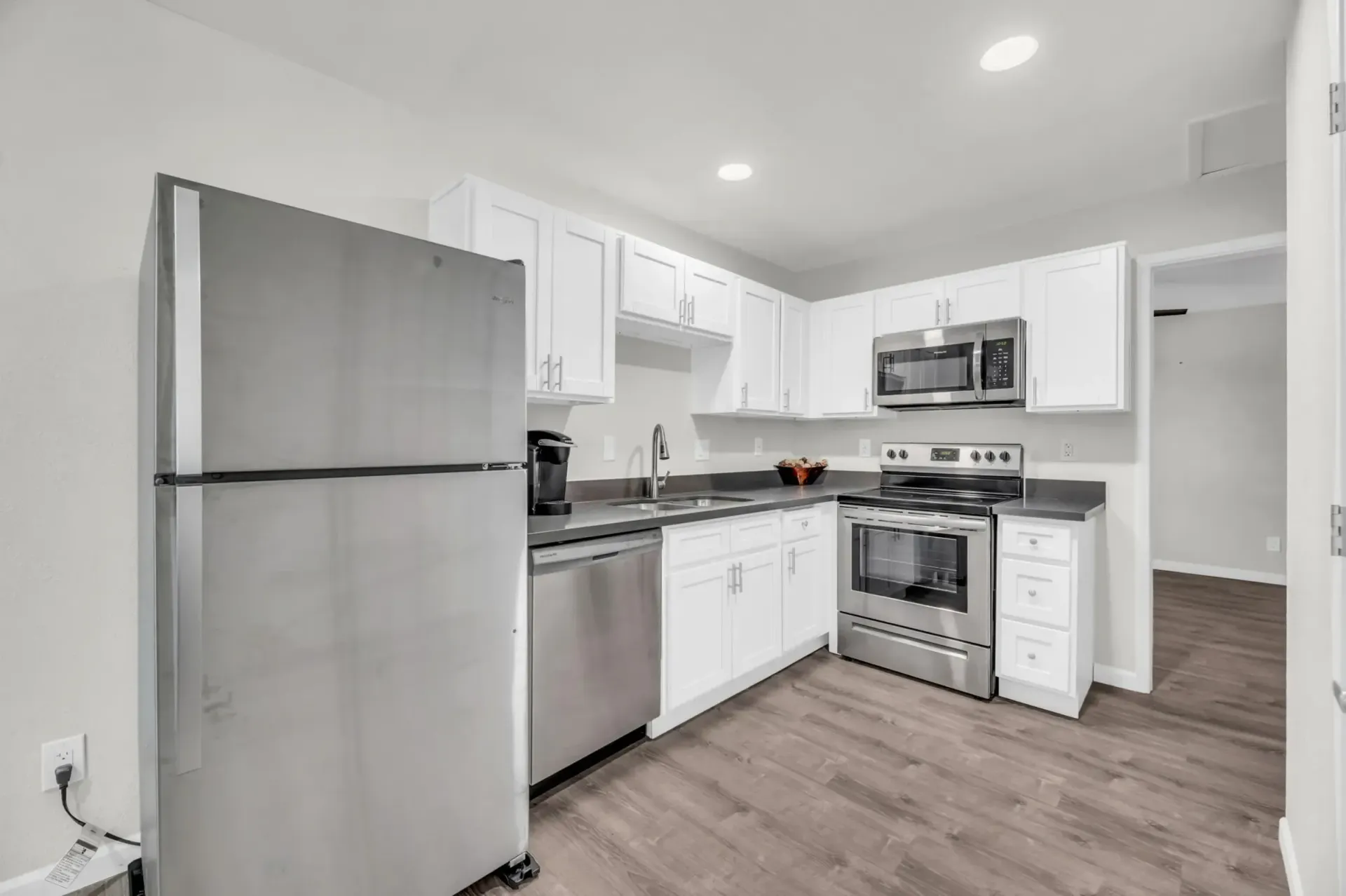 a kitchen with stainless steel appliances and white cabinets