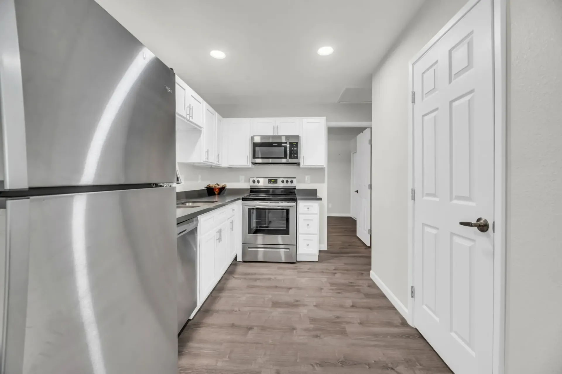 a kitchen with stainless steel appliances and white cabinets