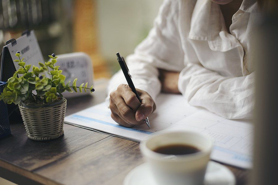 woman writing in the paper