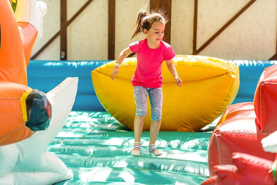 kid standing in the inflatable playground