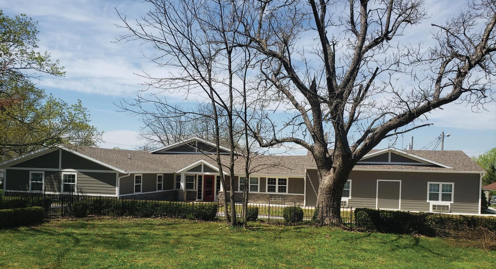 A large house with a large tree in front of it.