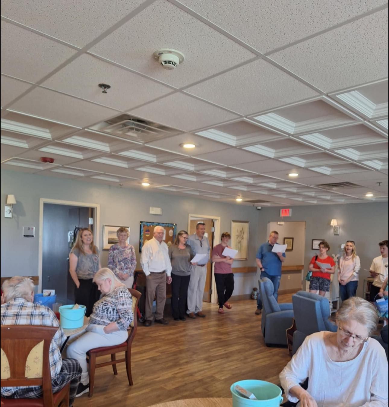 A group of people are gathered in a large room