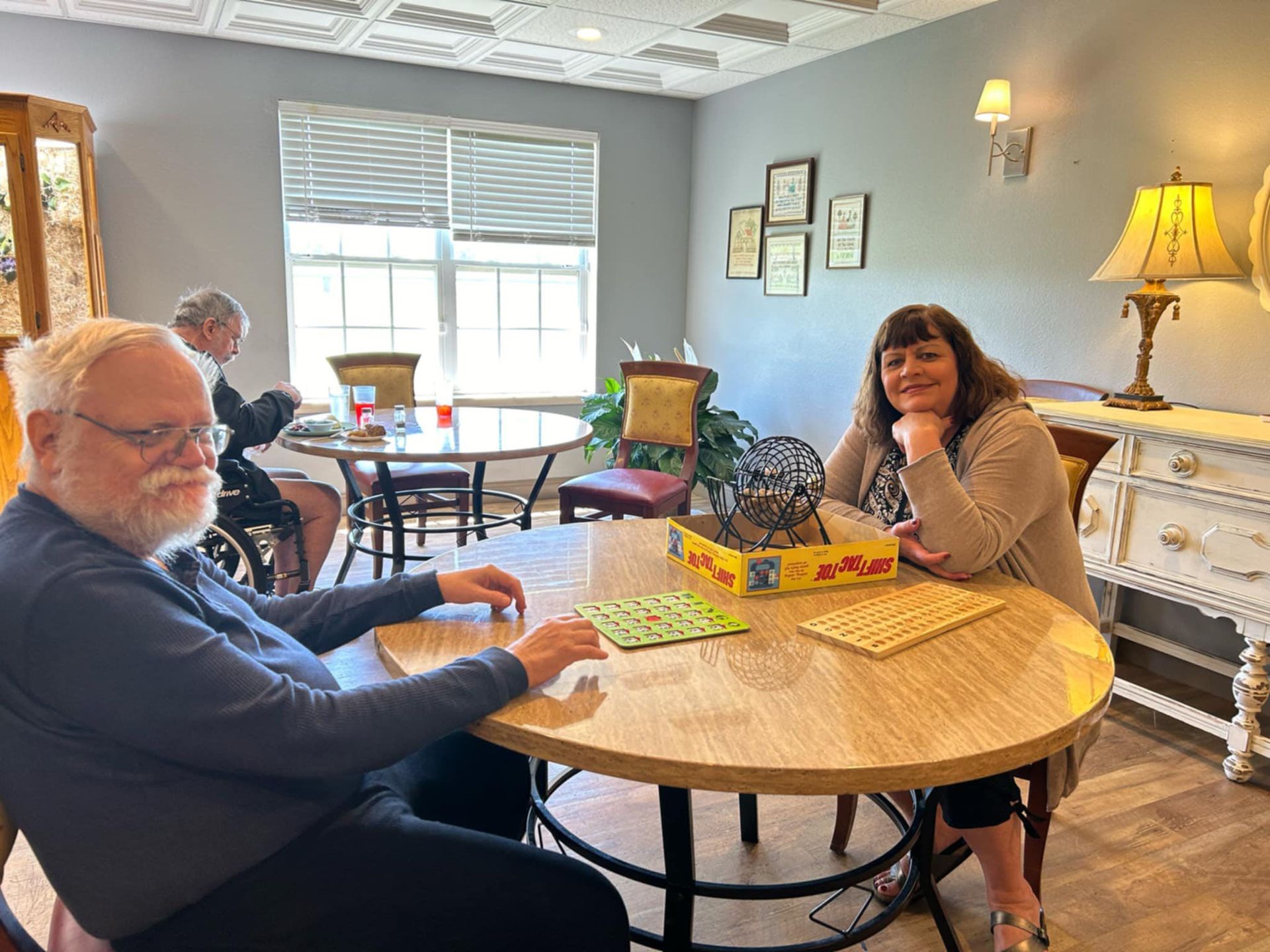 A group of people are sitting around a table playing a game.
