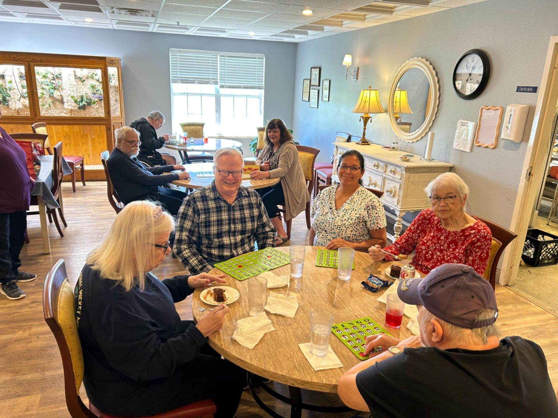 A group of people are sitting around a table playing bingo.