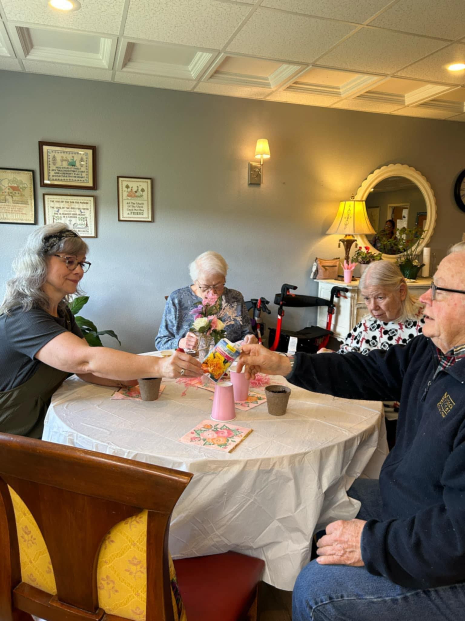 A group of people are sitting around a table drinking tea.