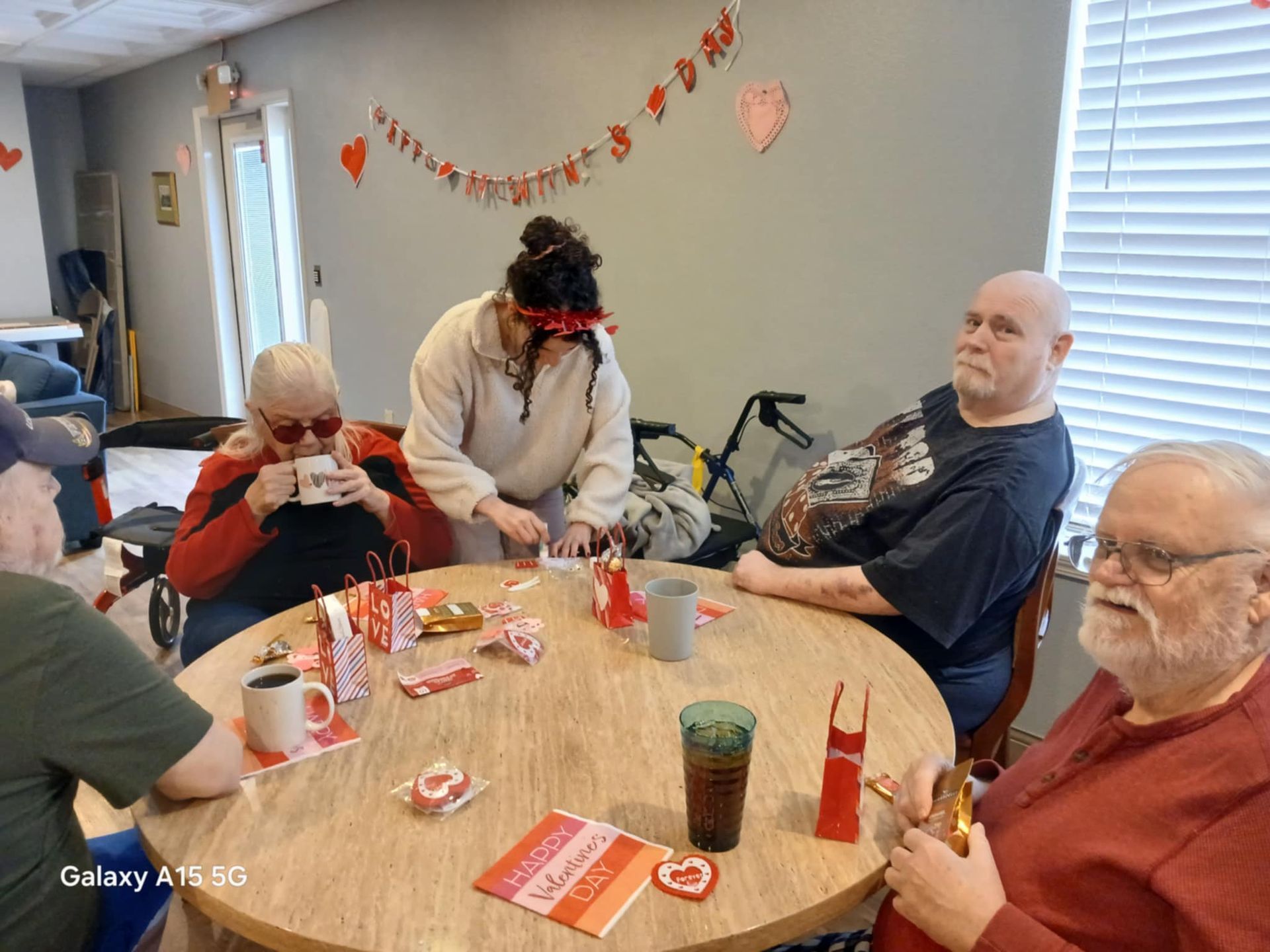 A group of people are sitting around a table in a room.