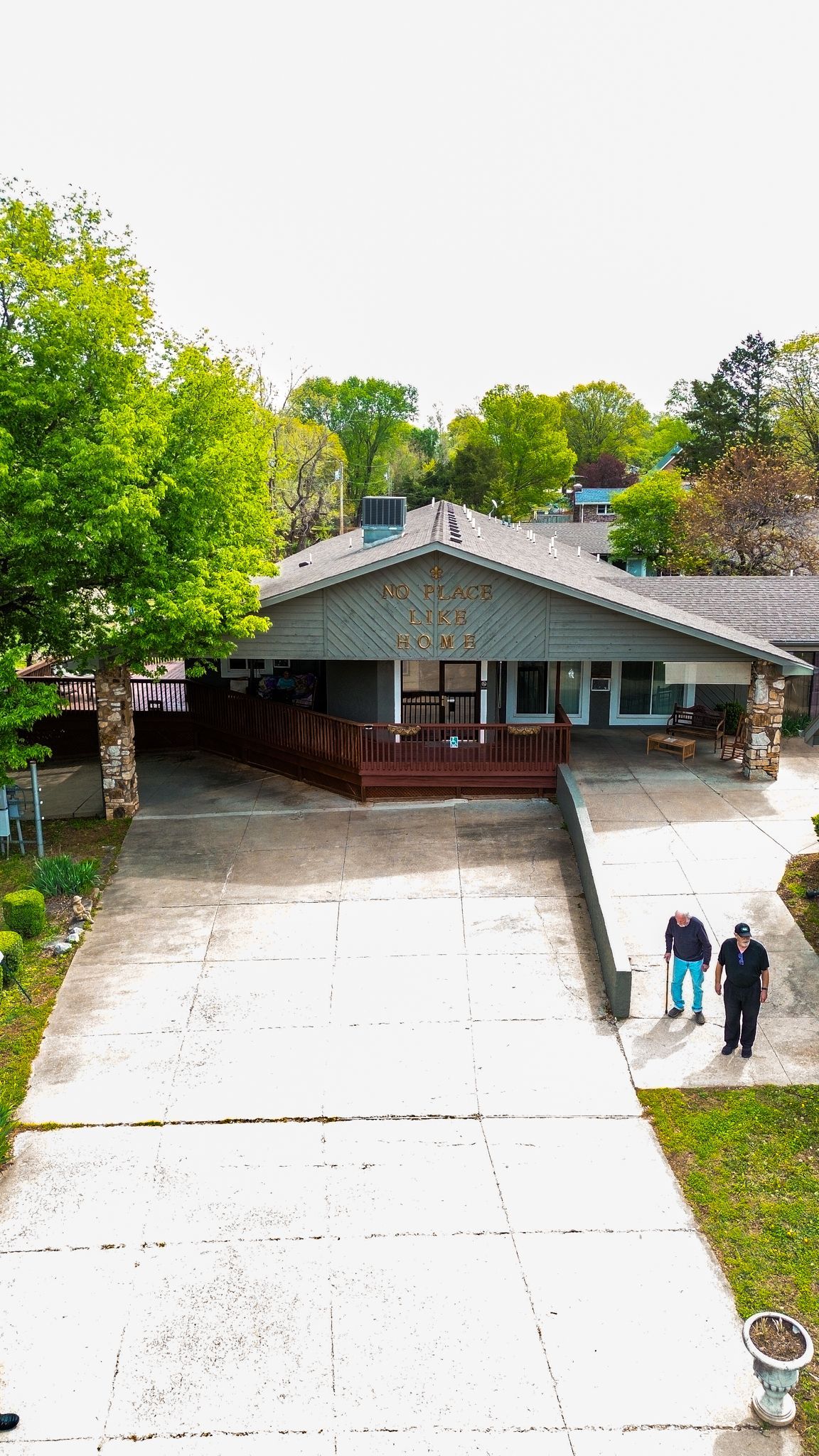 An aerial view of a couple standing in front of a house.