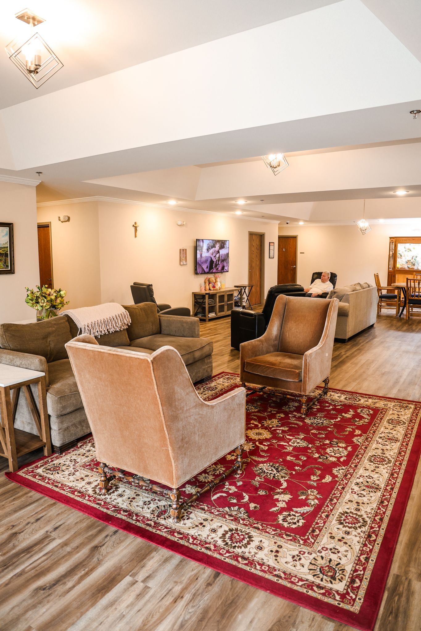 A living room filled with furniture and a rug.