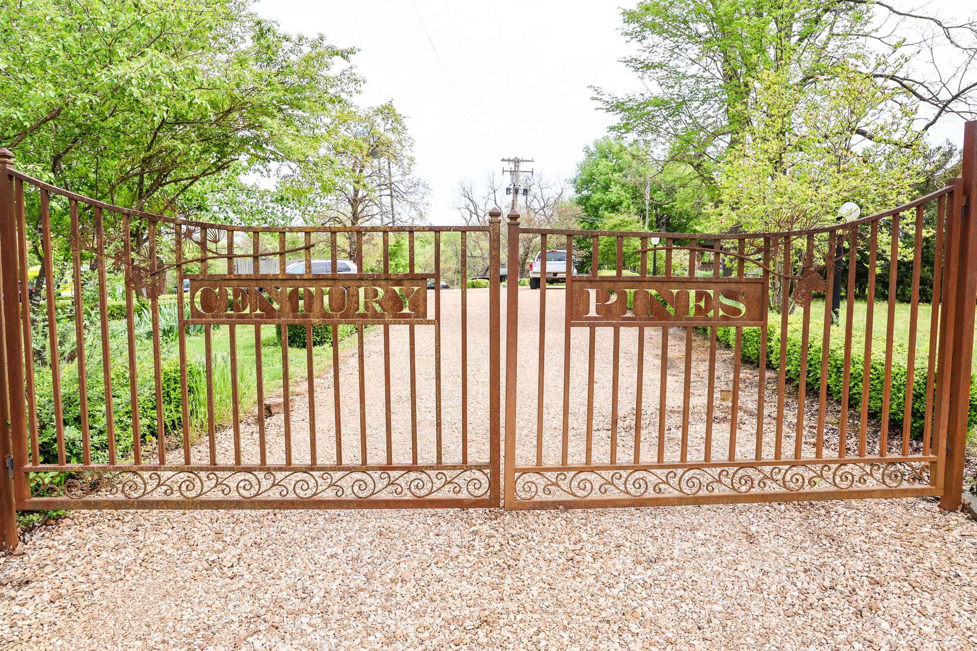 A rusty metal gate with the words century homes written on it
