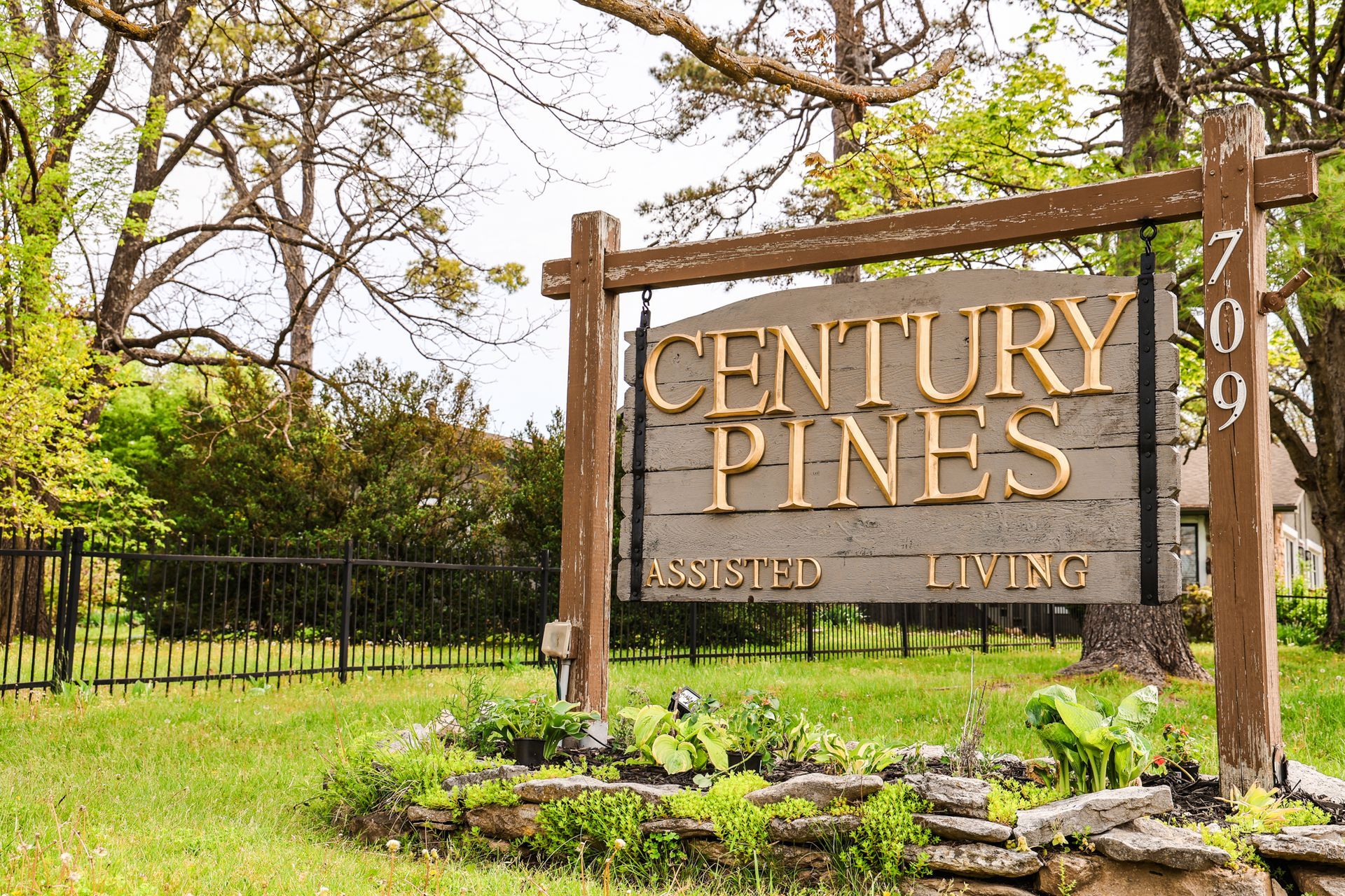 A wooden sign that says century pines on it