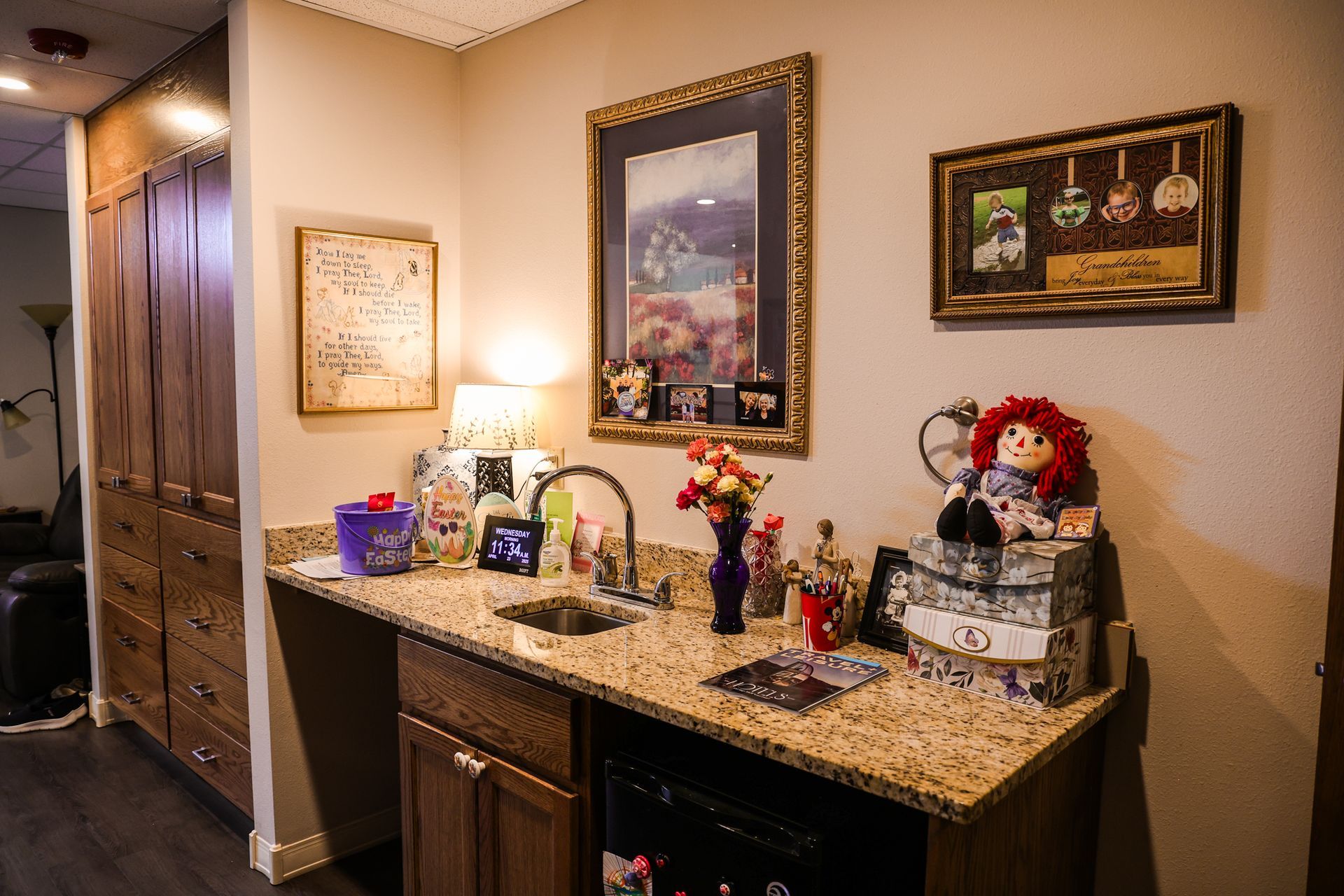 A kitchen with a sink , cabinets , and a refrigerator.