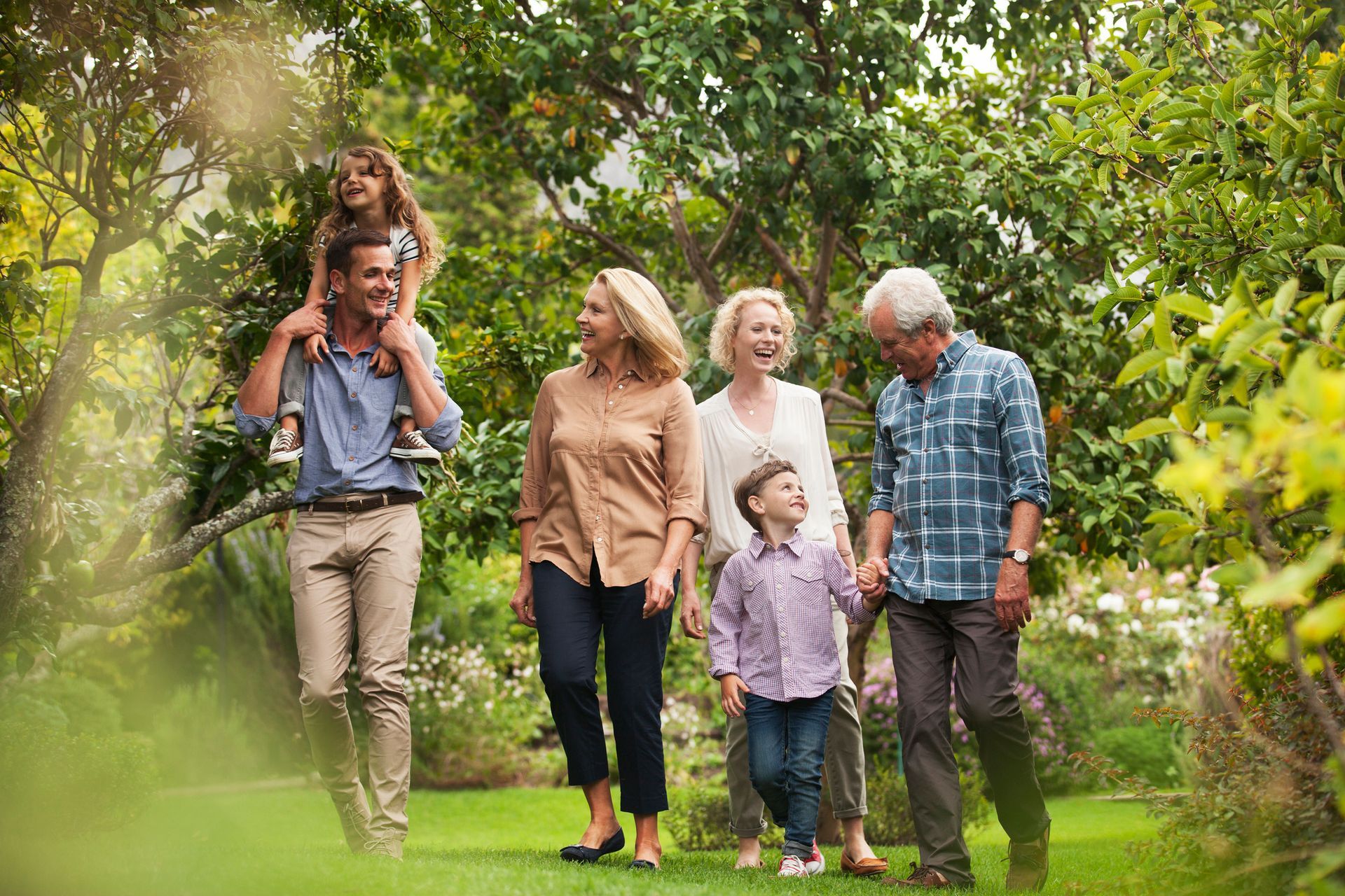 A family is walking through a park together.