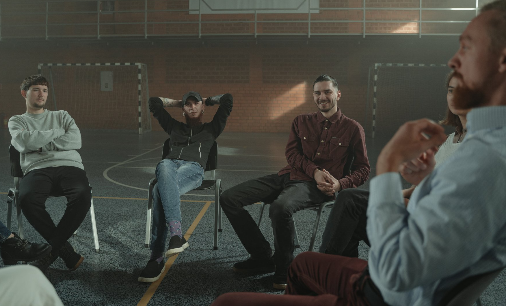Group of men sitting in chairs for a group counseling session in Austin