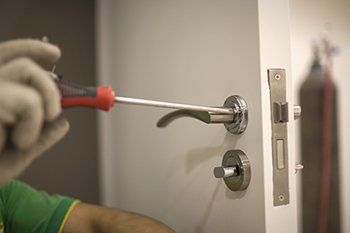 Locksmith fixing door lock and handle