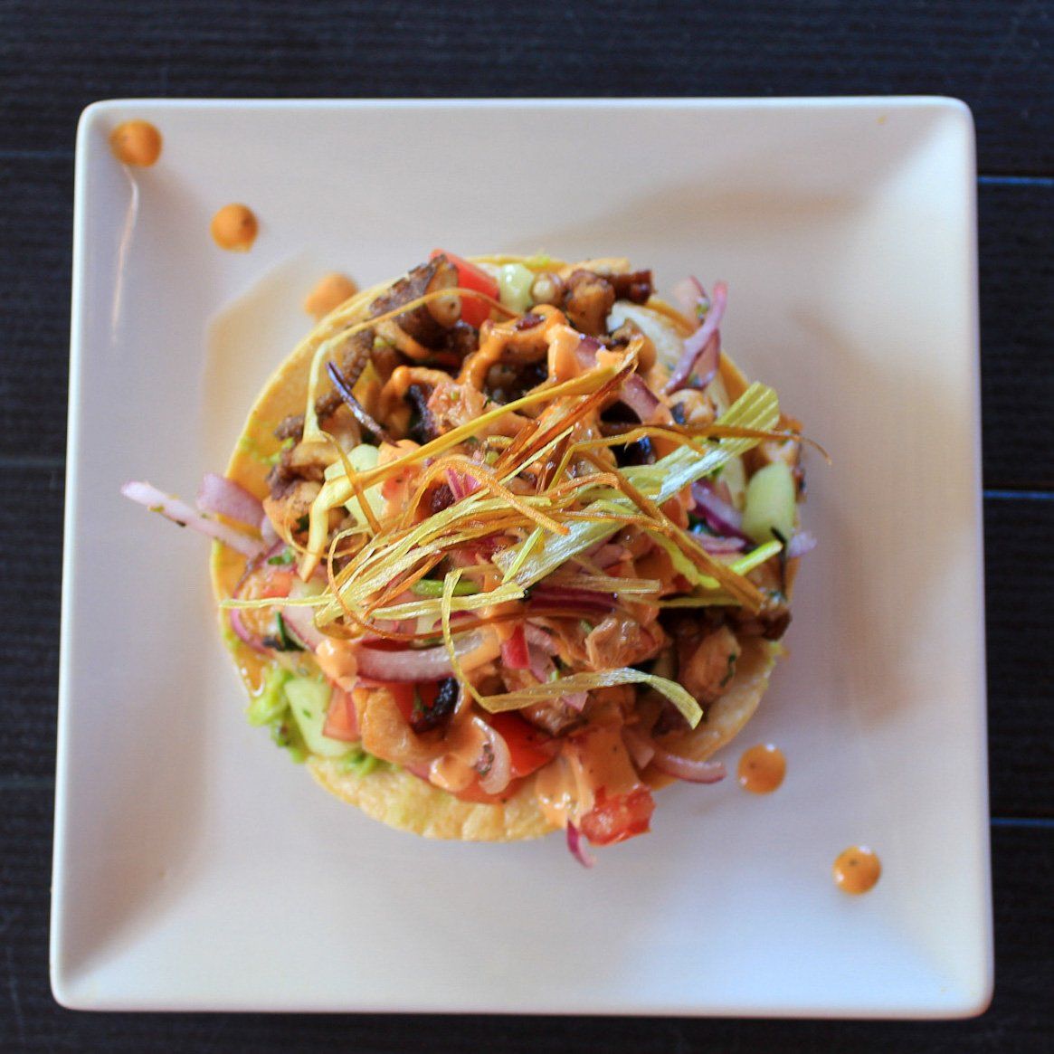 A white plate with a salad on it