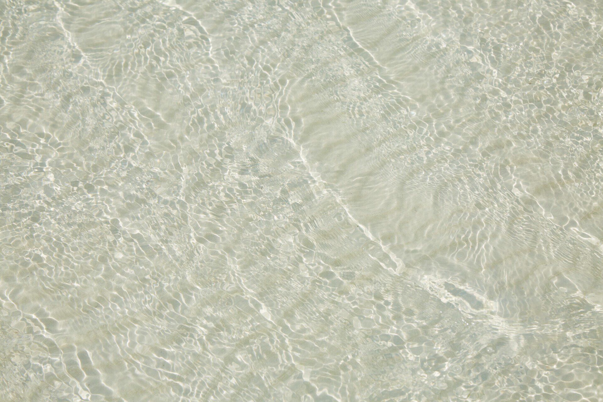 A close up of a body of water on a beach.