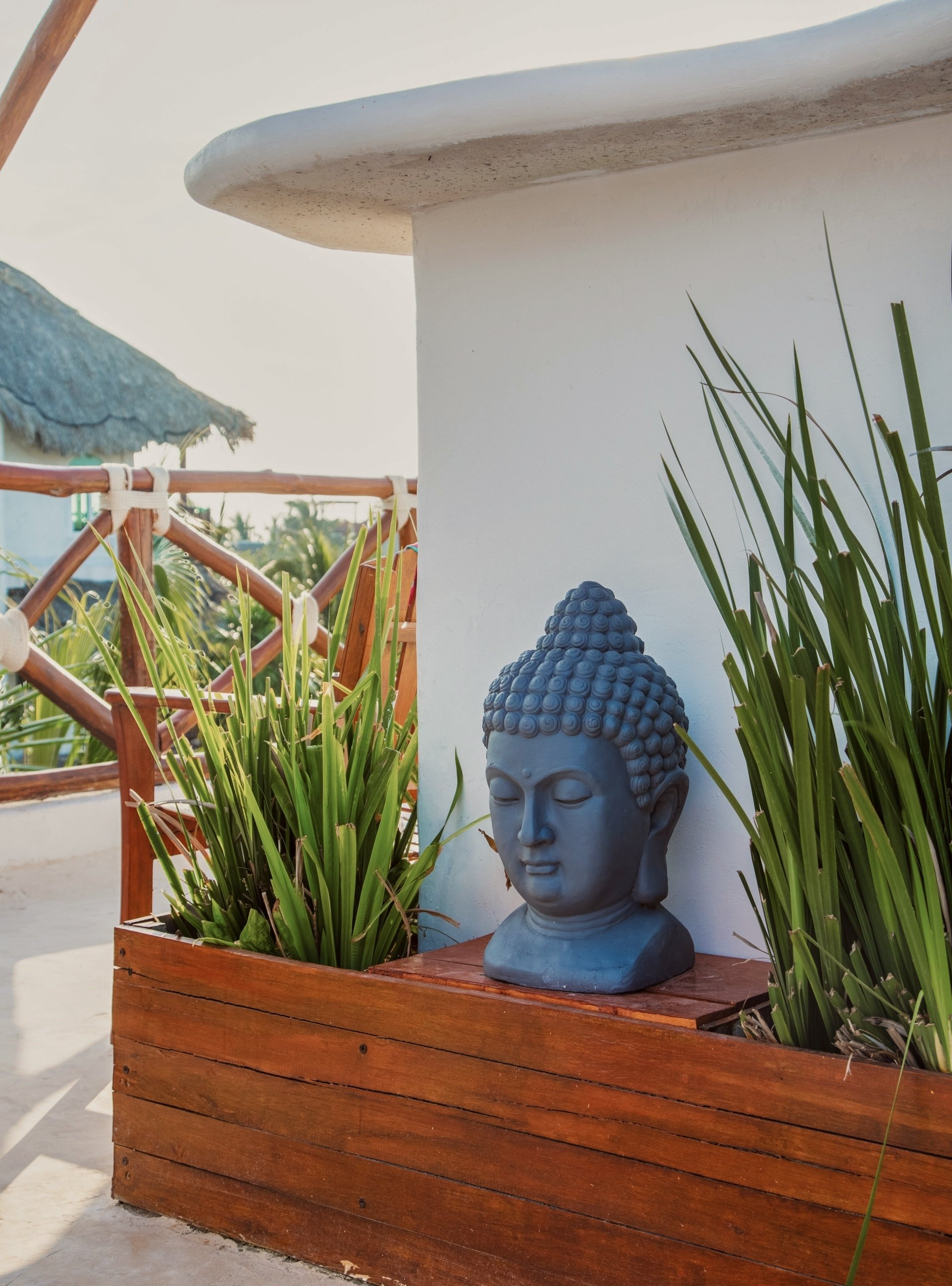 a garden with statue of a Buddha