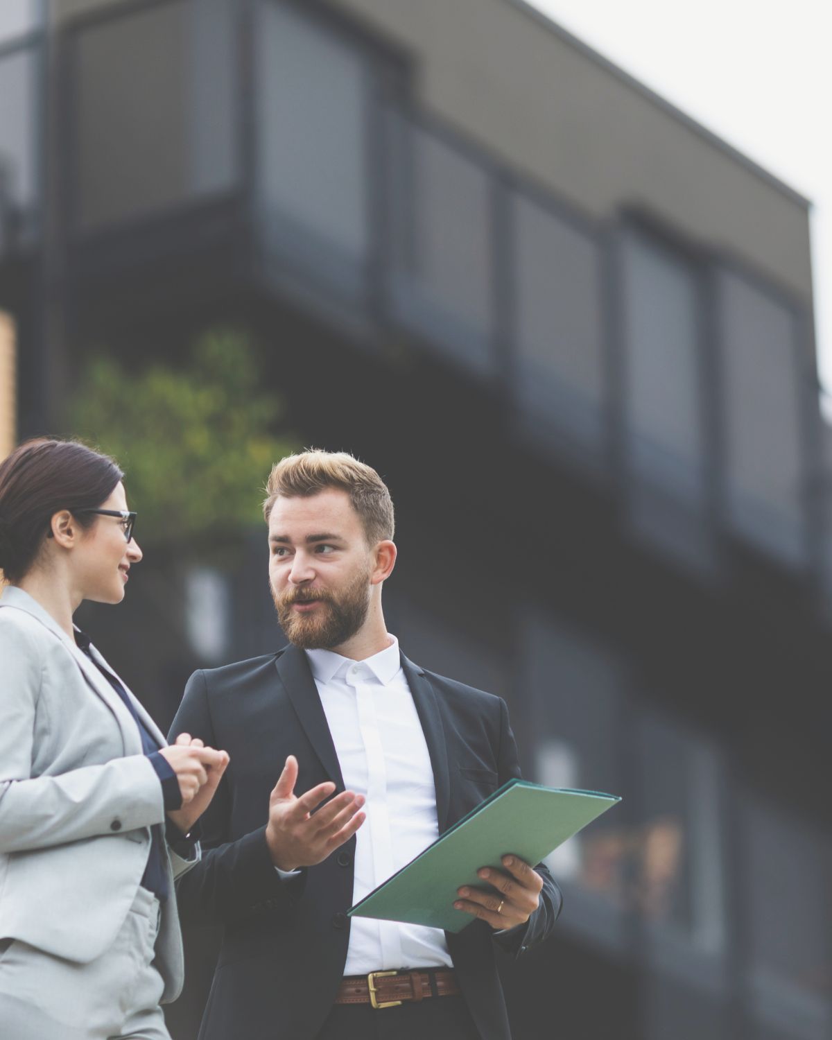 CPA helping real estate investor in front of new property or potential deal.