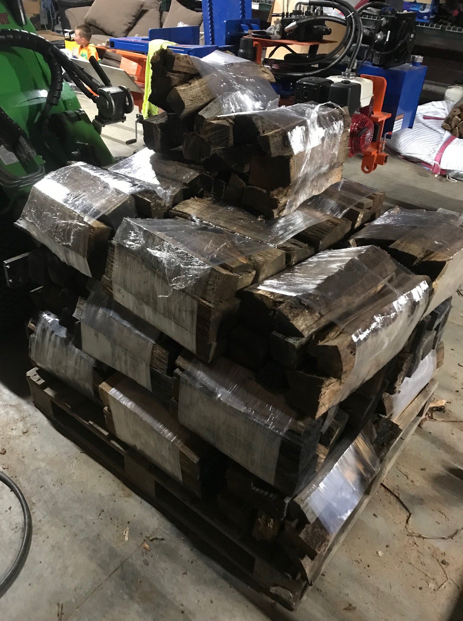 A pile of wood is sitting on top of a wooden pallet.