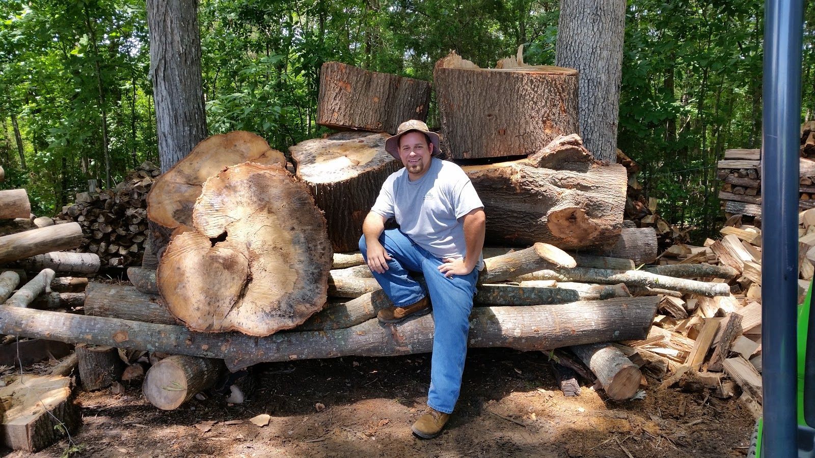 A black wood stove is sitting in front of a stone wall