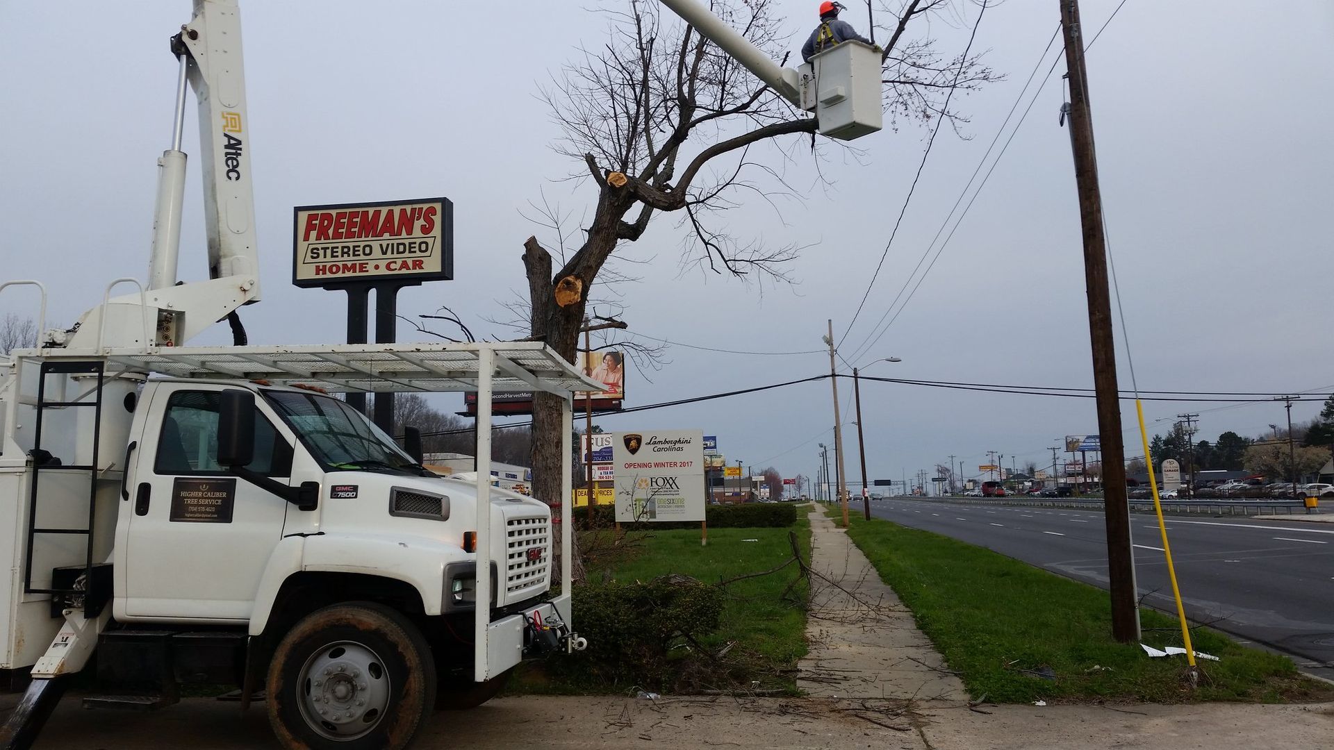 A white truck is parked in front of a pizza hut sign