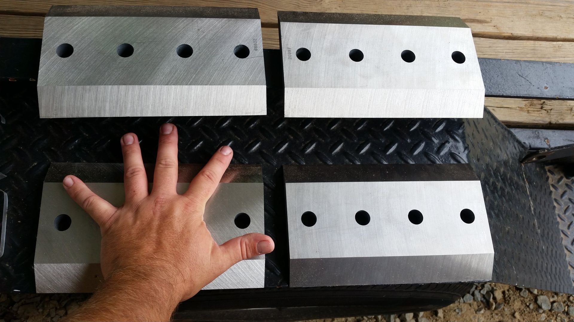 A person 's hand is reaching for a piece of metal