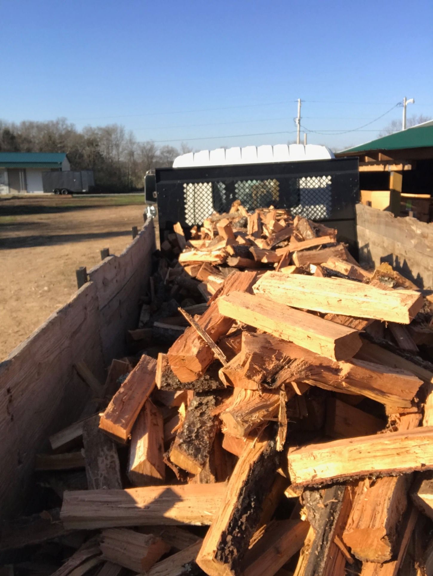 A pile of wood is sitting in the back of a truck.