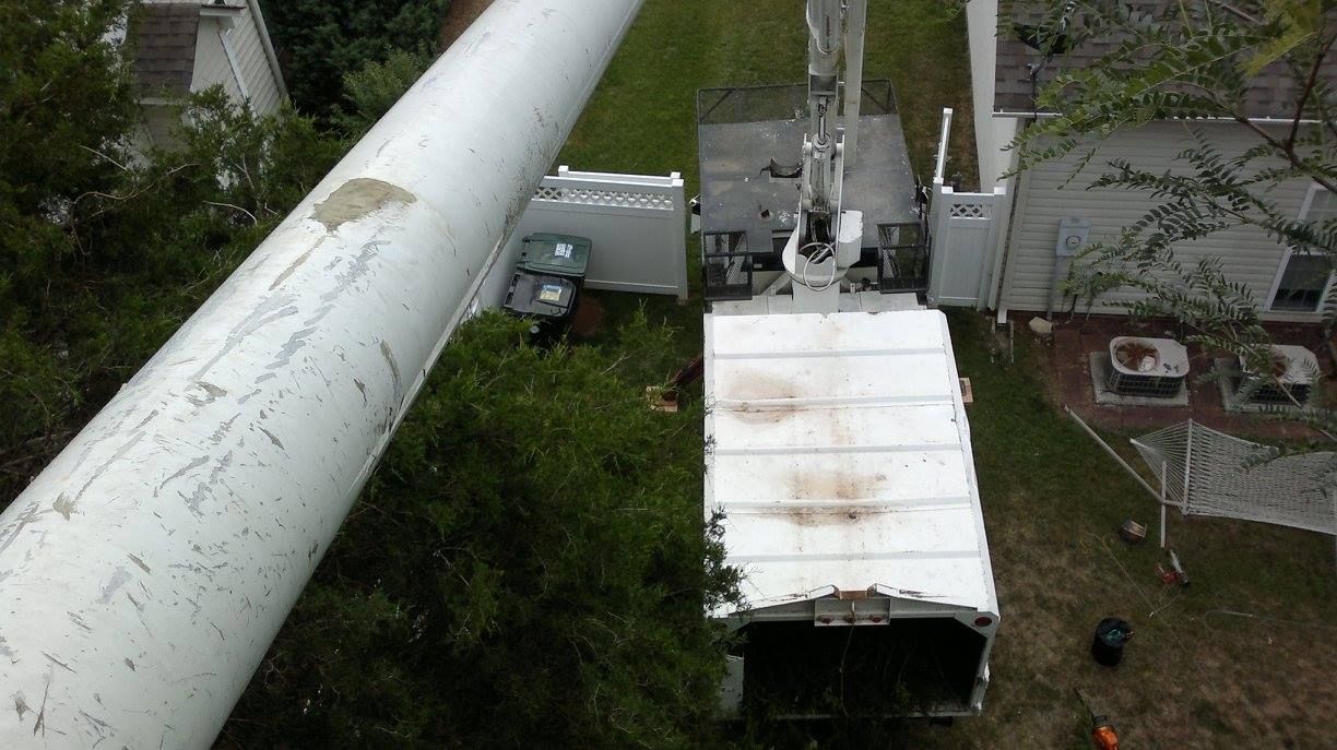 An aerial view of a tree cutting truck in a backyard.