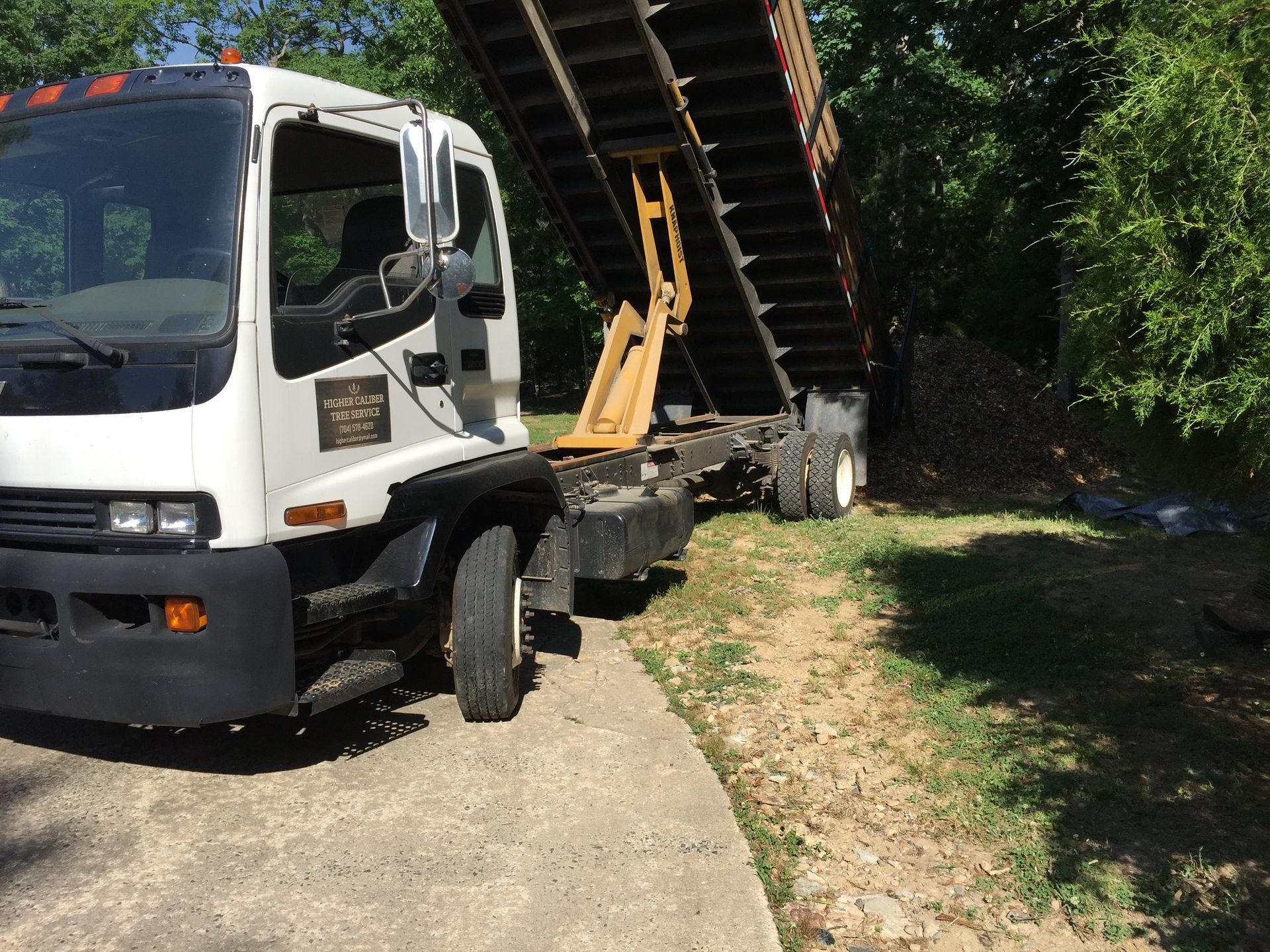 A dump truck is parked on the side of the road.