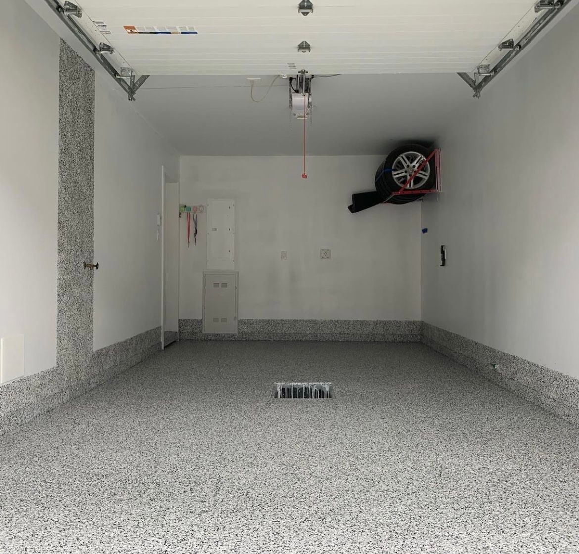 An empty garage with a tire hanging from the ceiling