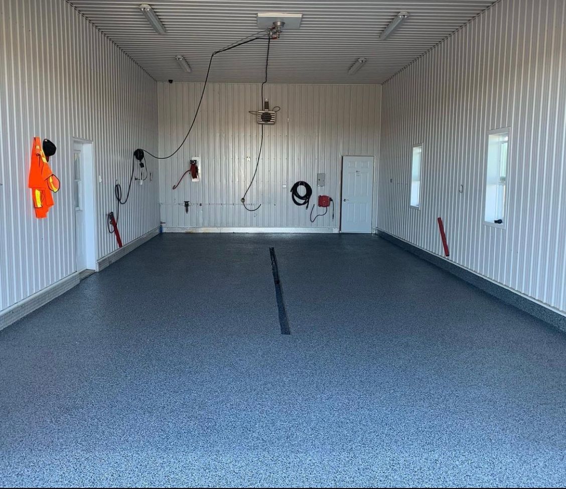 A garage with a gray floor and white walls