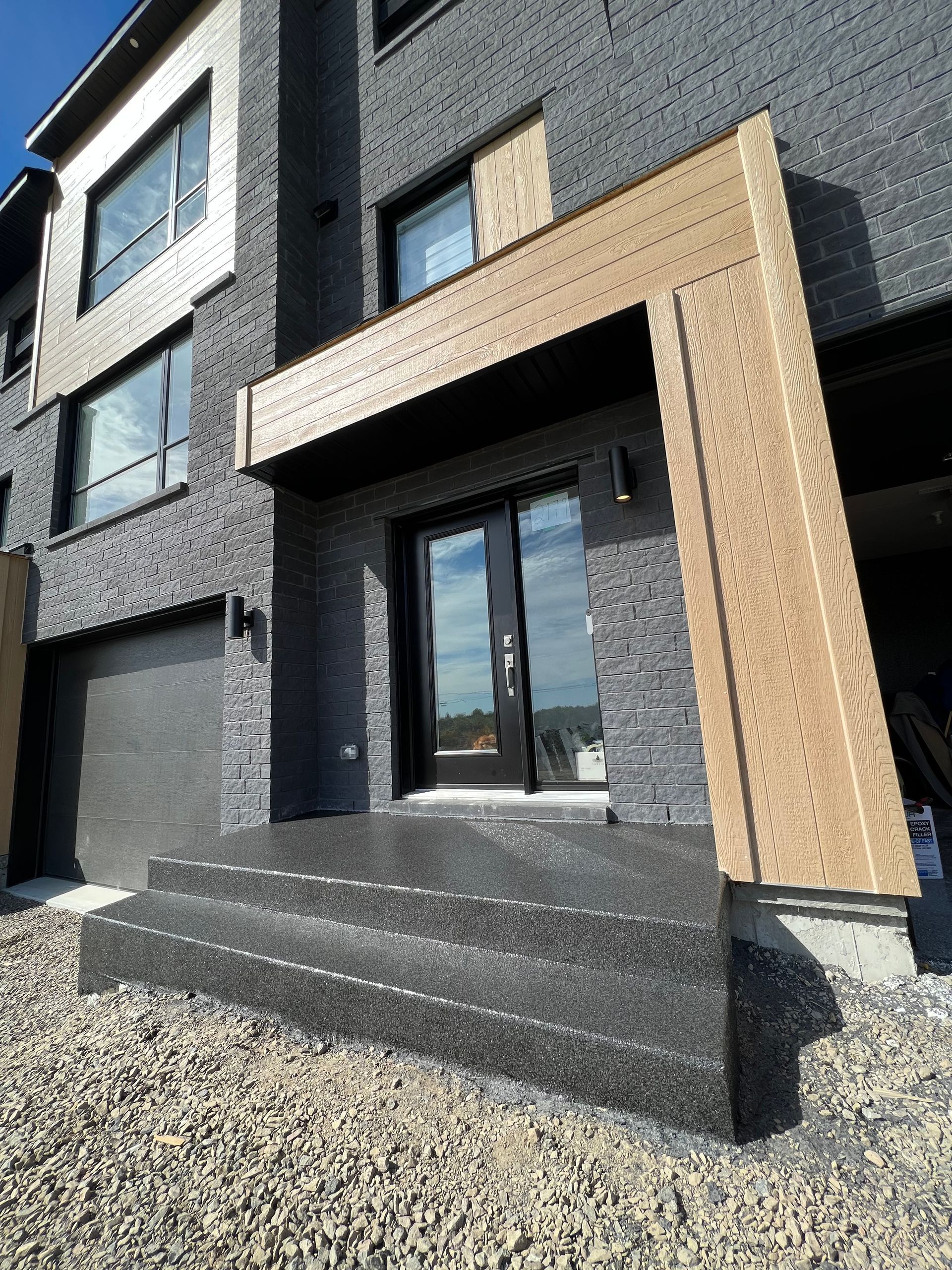 A large brick house with stairs leading up to the front door.