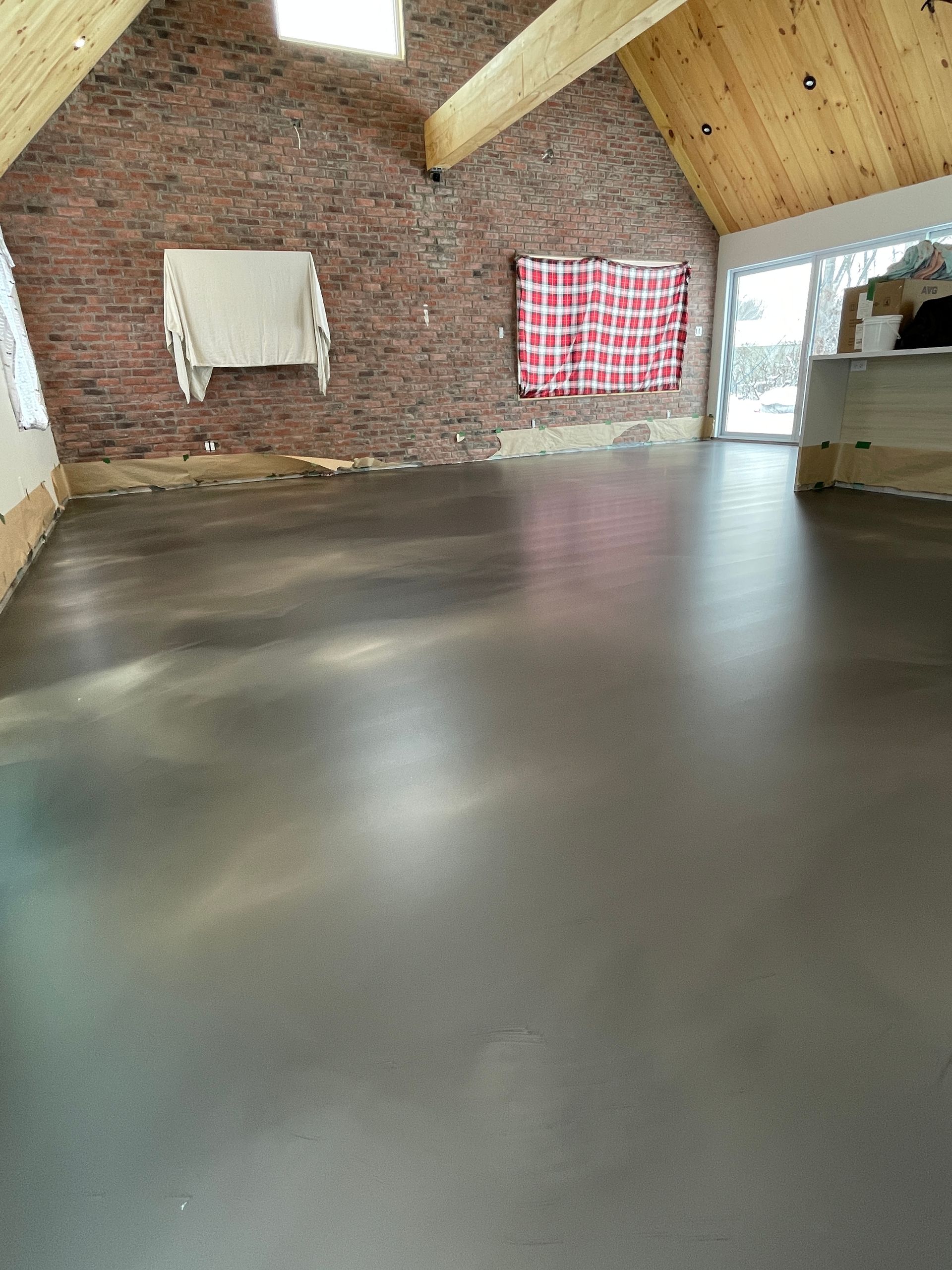 A room with a brick wall and a concrete floor.