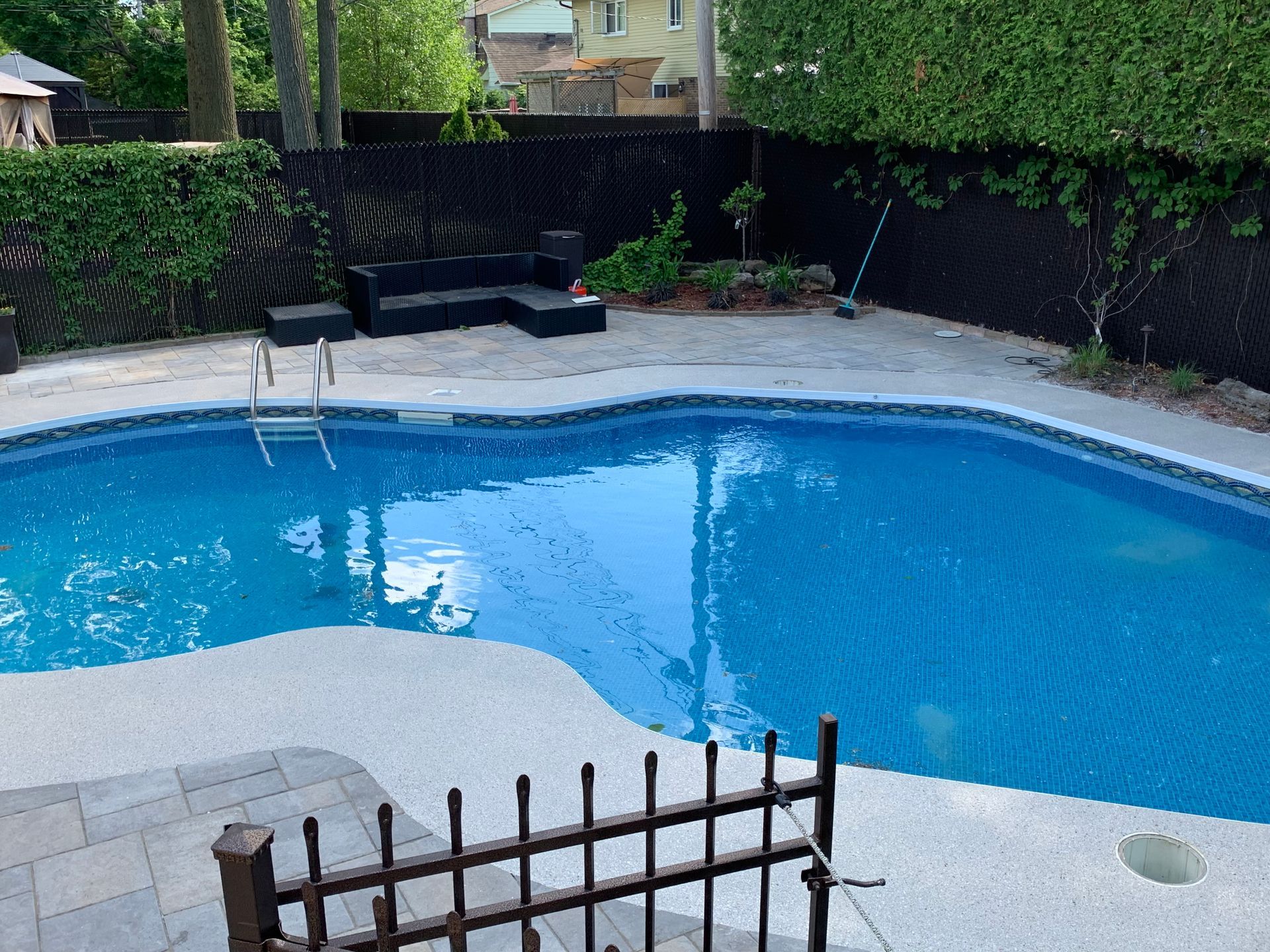 A large swimming pool with a fence around it